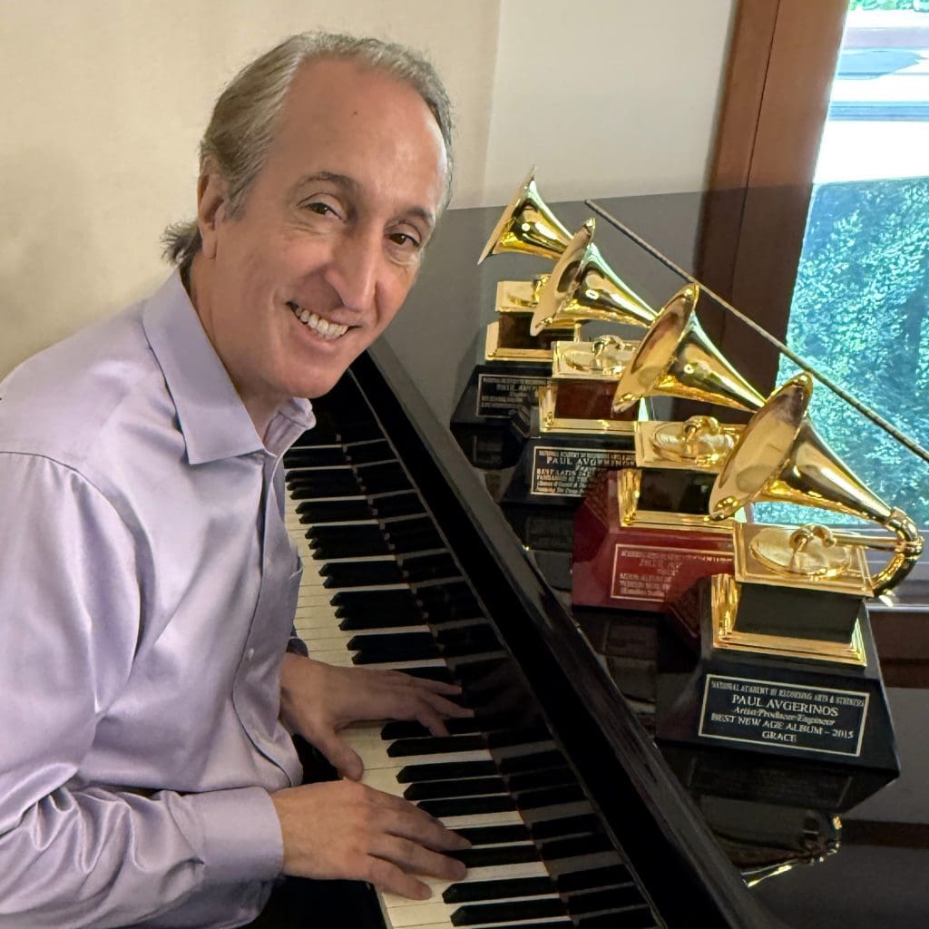 Paul Avgerinos at the piano with Grammy awards