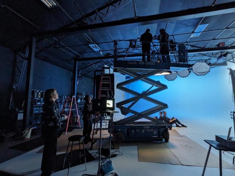 Director Lindsay Gauthier watching lighting and camera setup during filming.