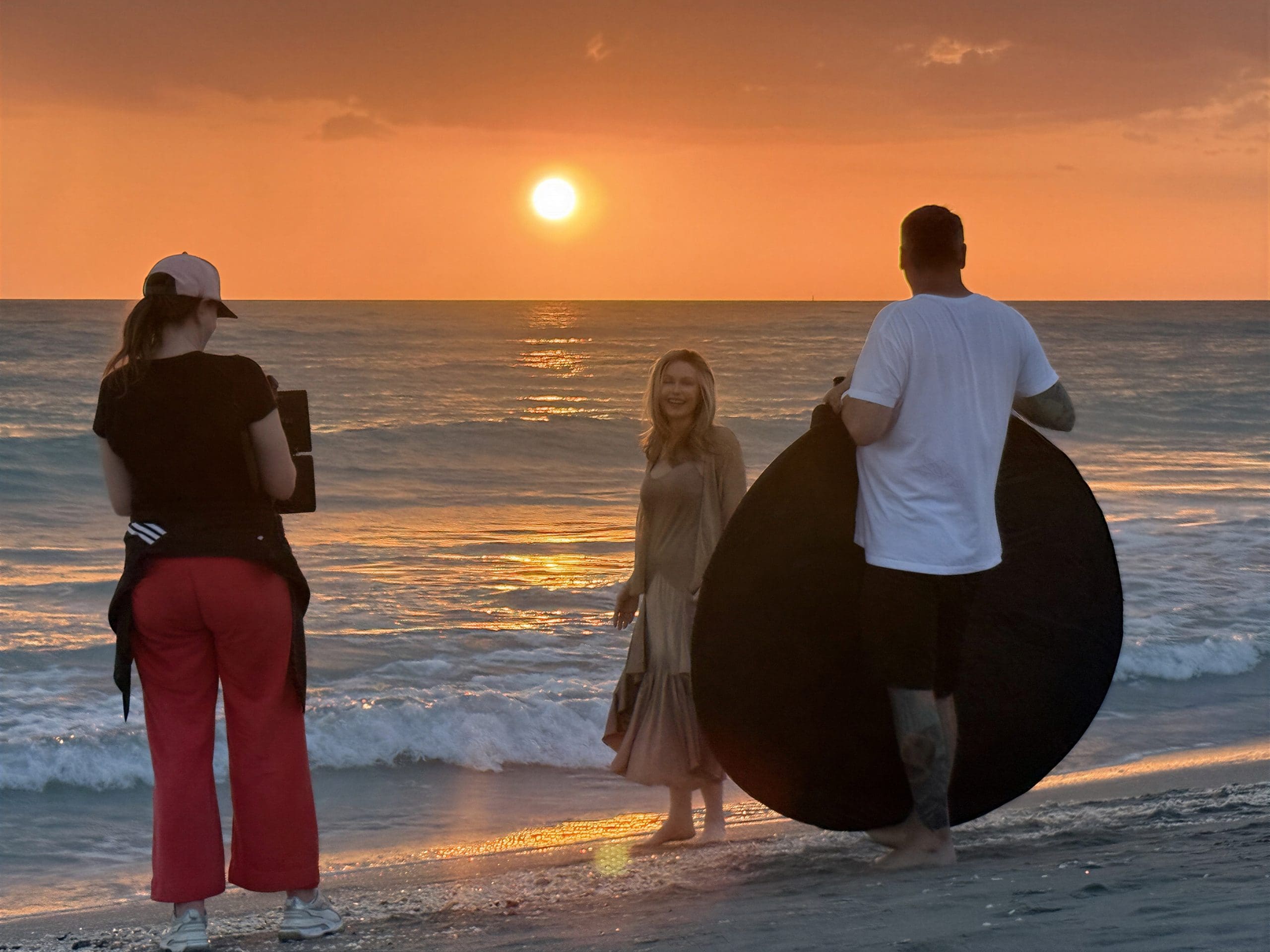 Filming on the beach during sunset